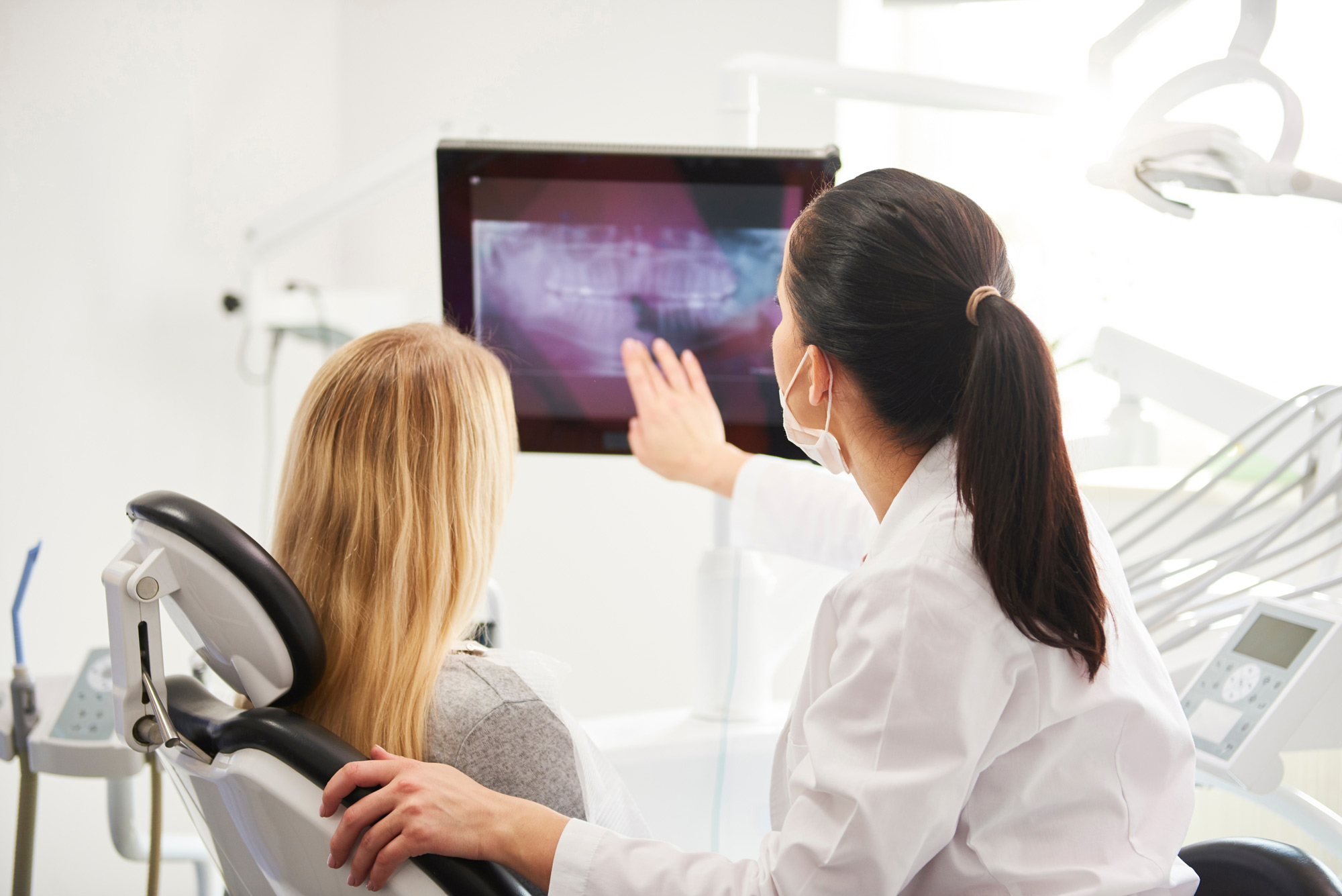 A dentist explaining a dental appliance to a patient at St. Louis County Dental.